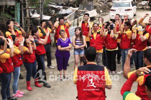 World Mission Society Church of God volunteers cheering and helping family after Hurricane Maria in Puerto Rico