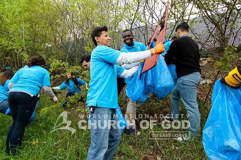 ASEZ volunteers removing trash from vegetation near Allard Drive in Manchester, NH