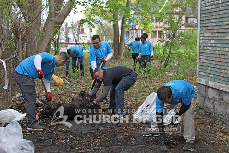 ASEZ volunteers cleaning up a vacant property in Syracuse as part of the Reduce Crime Together campaign