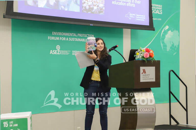 Girl explaining something to ASEZ WAO members during the Environmental Protection Forum