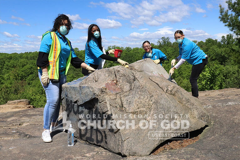 Volunteers from ASEZ removing graffiti at the Cranberry Lake Preserve