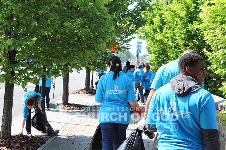 ASEZ volunteers cleaning trash from the sidewalk near JCTC