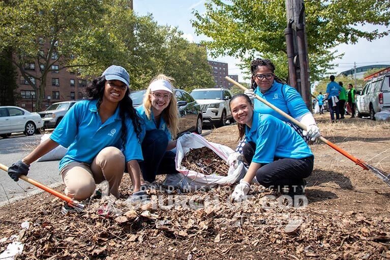 ASEZ volunteers joyfully removing trash from Randall Ave in the Bronx