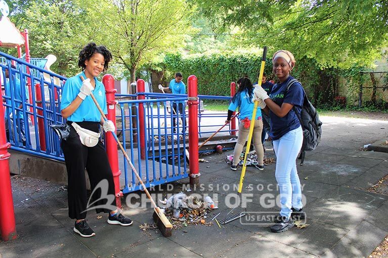 ASEZ volunteers removing trash from a playground at Pelton Park