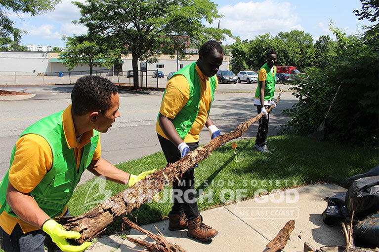 WMSCOG volunteer removing large pieces of debris from Howard Street in Nashua, NH.