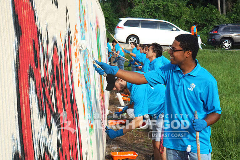 ASEZ volunteers painting over graffiti
