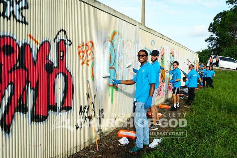 ASEZ volunteers cheerfully removing graffiti
