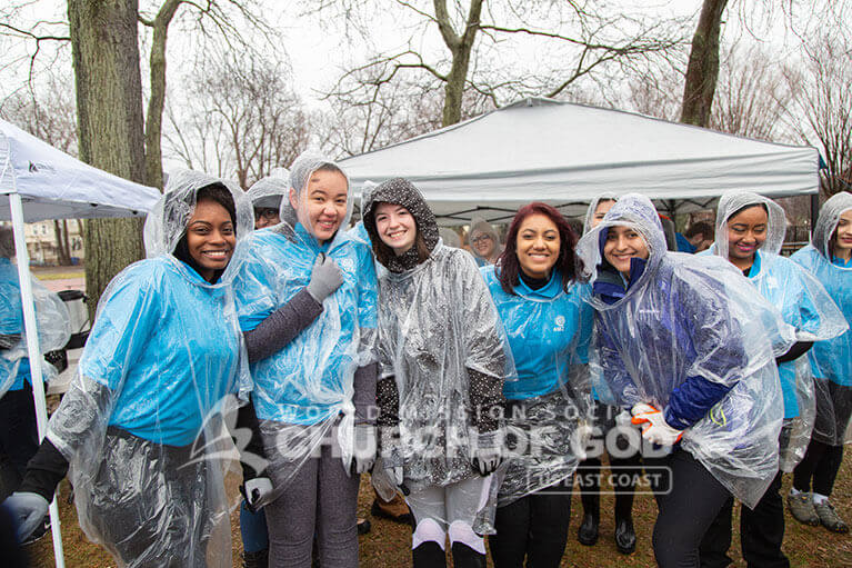 ASEZ volunteers huddled up together to stay warm after working hard to clean up their neighborhood.