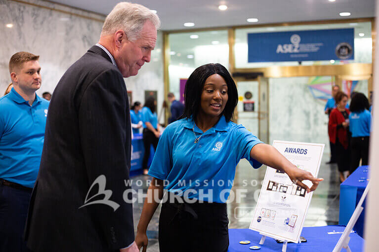 ASEZ volunteer explaining about their volunteer work to a government official at the NYS Capitol