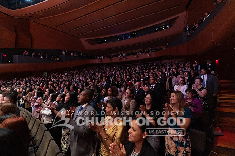 Audience members giving a standing ovation at the end of the ASEZ concert on August 11