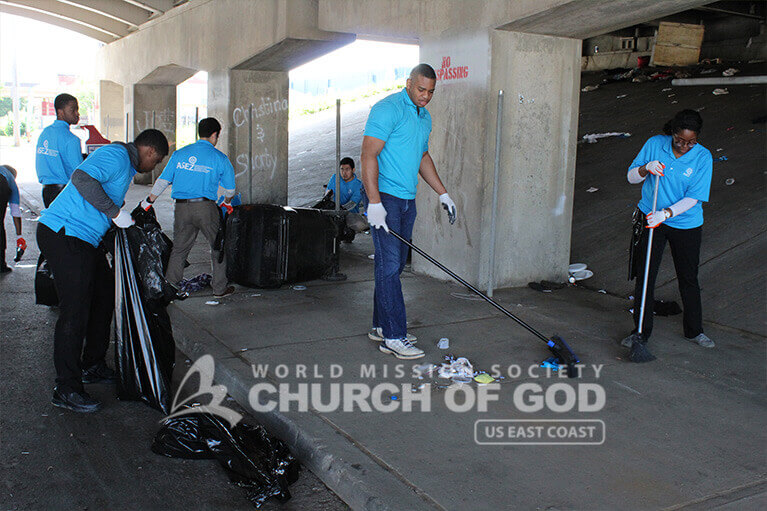 Volunteers from ASEZ removing garbage from around the JCTC campus